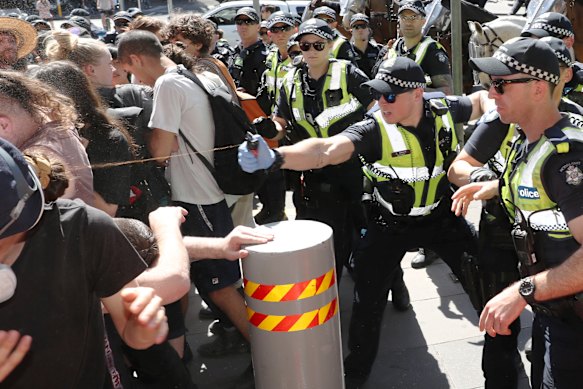 Police use pepper spray as protesters attempt to stop conference members entering during a protest against the International Mining and Resources Conference in Melbourne in October 2019.