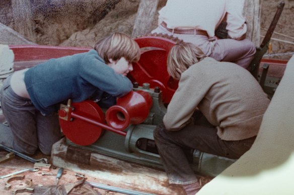 Rohan Burgess, left, as a boy, among volunteers including Andrew Cook, right, helping restore the paddle steamer Pevensey.