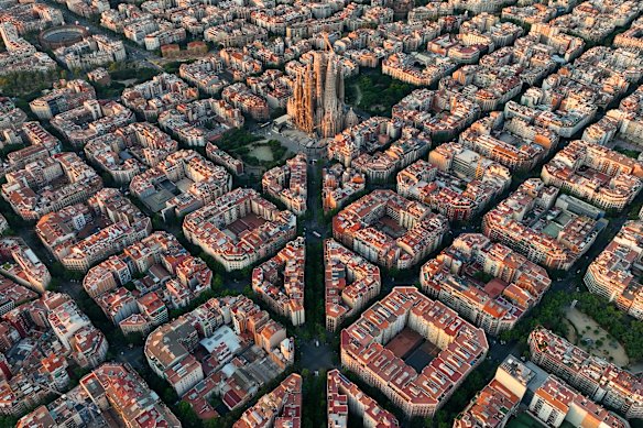 Gaudi’s La Sagrada Familia rises above the urban density of Barcelona.