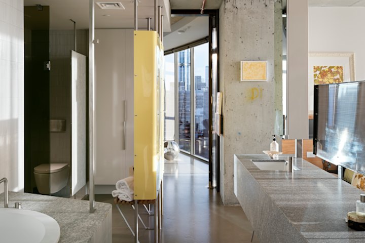 Two bedrooms were merged into the main suite and a stone vanity installed to create privacy between the bedroom and bathroom.