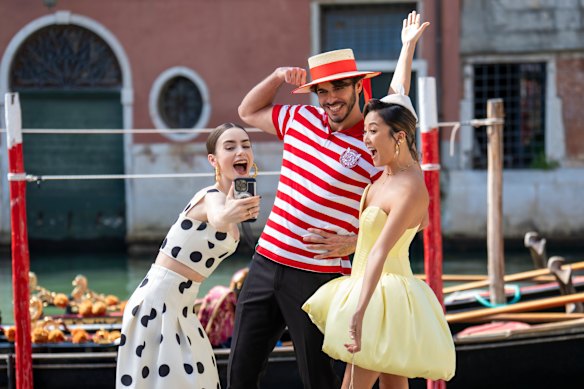 Lily Collins as Emily and Ashley Park as Mindy in Emily in Paris.