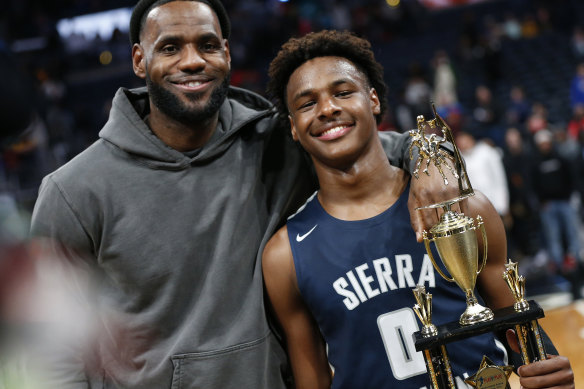 LeBron James, left, poses with his lad   Bronny successful  2019.