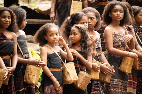 Women and girls of the Abui tribe get ready to perform a Lego-Lego dance of welcome.