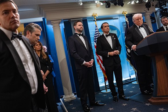 Trump, surrounded by members of his cabinet and the first lady, speaks to reporters after the incident.