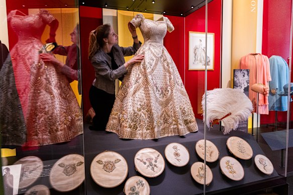 Cecilia Oliver, textile conservator, Royal Collection Trust, makes final adjustments.
