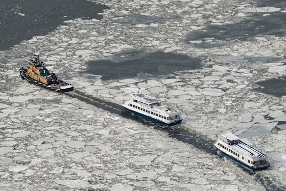 New York Waterway ferries move as ice floats on the Hudson River seen from the Edge sky deck at Hudson Yards, Tuesday, Jan. 27, 2026, in New York.