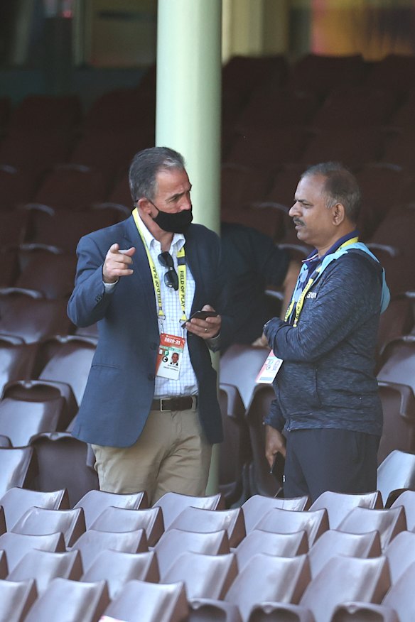 Carroll (left) speaking with a member of India’s team management after a day’s play of the SCG Test in 2021.