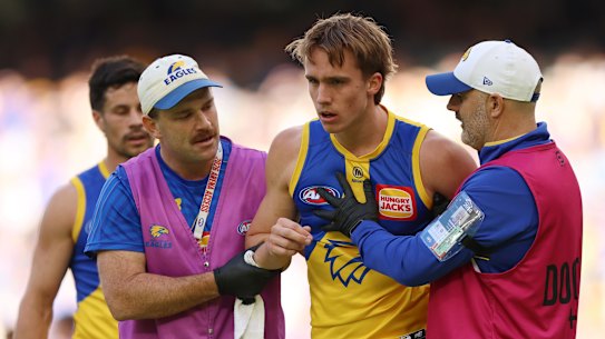 West Coast’s Hamish Davis after the tackle by North Melbourne’s Paul Curtis.