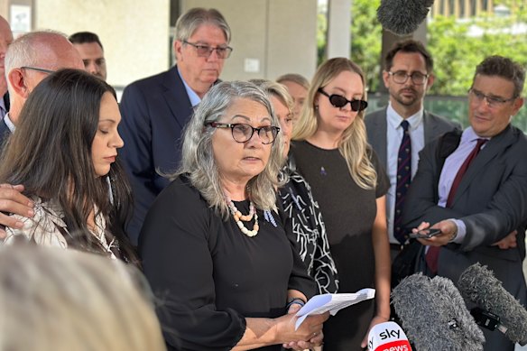 The families of Rachel McCrow and Matthew Arnold, led by Judy McCrow, outside Brisbane Magistrates Court after State Coroner Terry Ryan handed down his findings into the Wieambilla ambush.