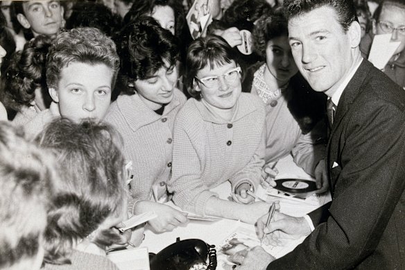 Col Joye signs autographs for fans in the band’s early days. 