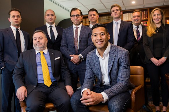 Stuart Wood AM, KC – seated at the left of Israel Folau – with the rest of the footballer’s legal team in 2019. 