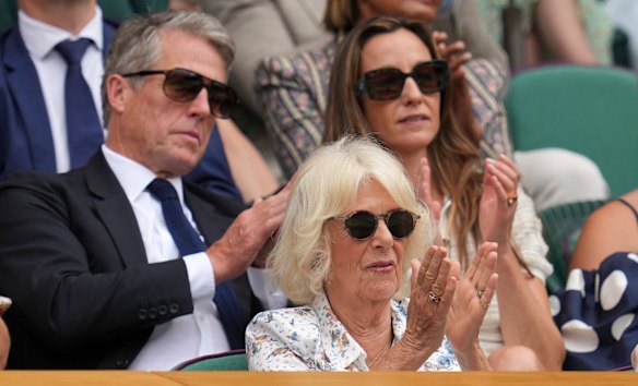 Queen Camilla was in Wimbledon’s royal box on Wednesday, where she spoke with actor Hugh Grant (left).