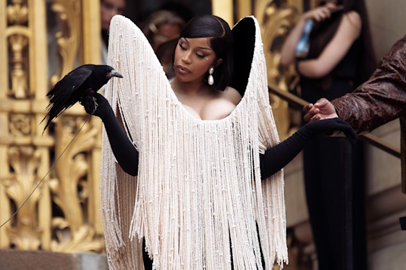 Cardi B accessorising with a crow at the Schiaparelli autumn/winter, 2025/2026 haute couture show in Paris.