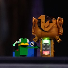 A Lego piece with a smart brick attached.