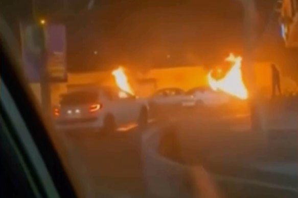 This video grab from footage released by Iranian state television shows burning vehicles during a night of mass protests in Tehran.