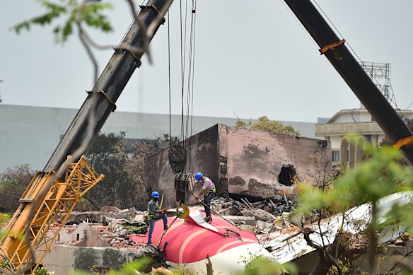 A crane retrieves part of the fuselage of the Air India Boeing 787 in Ahmedabad, India.
