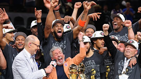 New York Knick owner James Dolan in the centre of the celebrations.