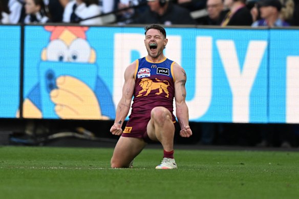 Lachie Neale celebrates his monster goal on the run after being subbed into the grand final at half-time.