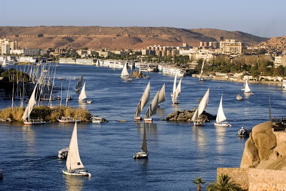 Traditional Egyptian felucca sailing boats  dot the Nile River at Aswan.