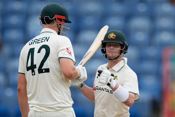 Australia’s Steve Smith chats with teammate Cameron Green during their partnership.