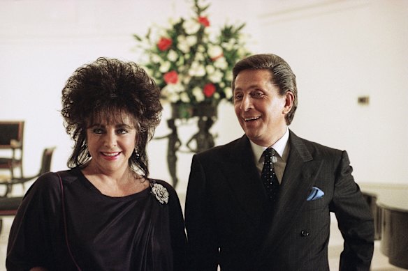 Elizabeth Taylor and Valentino Garavani pose for photographs in 1990.