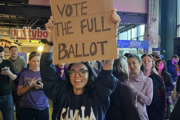 A woman holds up a sign at Party to the Polls in Durham, North Carolina, as early voting begins.