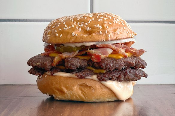 The HMC, a double beef burger with double cheese, HMC bacon, HMC sauce, pickles and onion on a toasted bun.