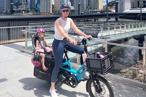 Harriet Muir rides an e-cargo bike in Brisbane.