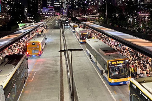 Crowds wait for buses after Riverfire 2025 in Brisbane.