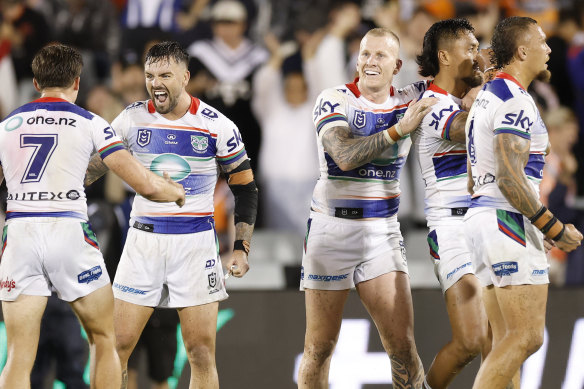 Warriors players celebrate their win over Wests Tigers.