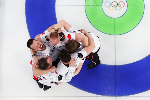 Curling gold medallists Brad Jacobs, Marc Kennedy, Brett Gallant and Ben Hebert, of Team Canada, celebrate victory with coach Paul Webster.