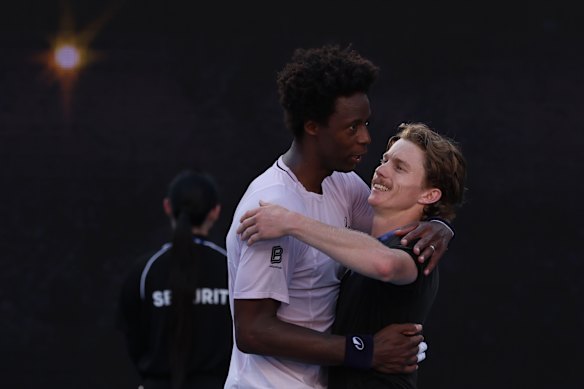 Gael Monfils and Dane Sweeny embrace after the Australian’s victory.