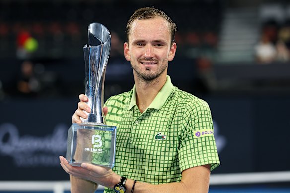 Medvedev holds the winner’s trophy.