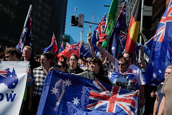 The crowd waving Australian flags marched from Central Station to Victoria Park, as a neo-Nazi organisation handed out fliers.