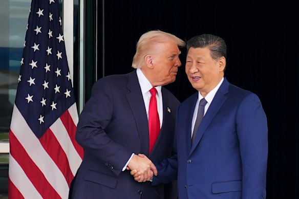 Donald Trump and Xi Jinping shake hands after their talks in South Korea in October. They are due to meet again in Beijing in April. 