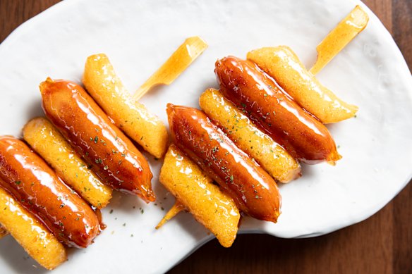  glossy skewers of rice cakes and hot dogs.