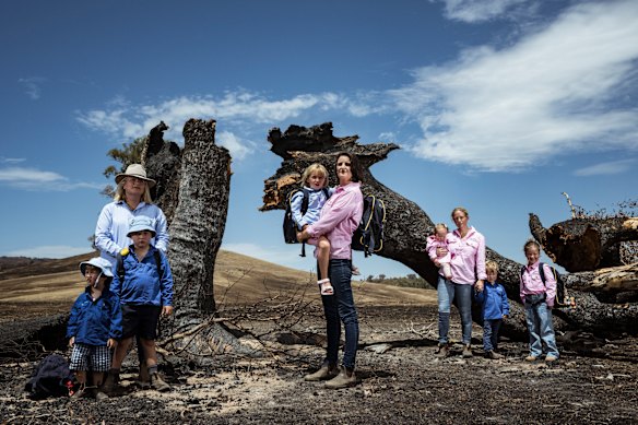 Annabelle Cleeland and her five-year-old daughter Quinn (c) with Lou Webb (l) and her children Tom and Fred, 3, and George, 6, and Felicity Jeffrey and her children Jemima,6, Sebastien,4 and Claudio,1, stand in the burnt out Jeffrey property in Whiteheads Creek. All three families homes were decimated by the Longwood fire in early January and now the kids are looking to head back to school. A number of schools and kindergartens in the Seymour area are either closed, have had delayed starts impacted by the bushfires. 