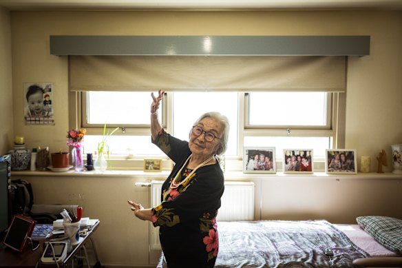 91-year-old Me Hui Gong, dances in her living room in her public housing unit, North Melbourne.