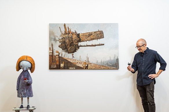 Artist and writer Shaun Tan with one of his artworks - ‘I Won’ - part of his upcoming exhibition of work from his 25-year anniversary of his book The Red Tree at the Beinart Gallery, Brunswick.