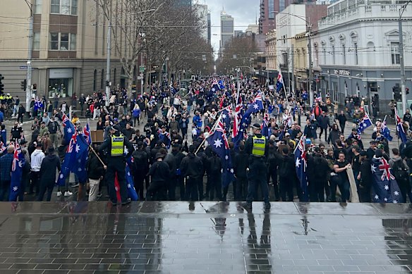 Police confronted by protesters outside Parliament House.