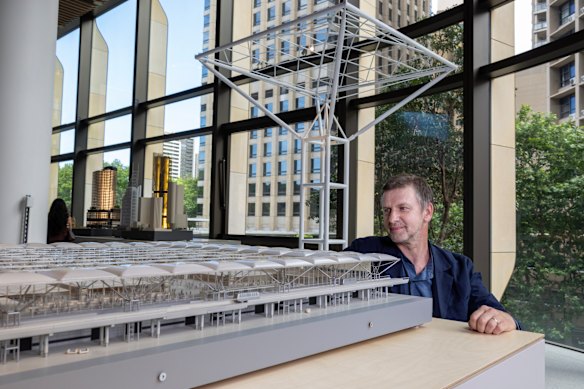 Muir Livingstone, a partner with Foster + Partners in Sydney, inspects a scale model of Stanstead Airport terminal building designed by the practice.  It opened in 1991 and turned the old design of terminals upside down. 