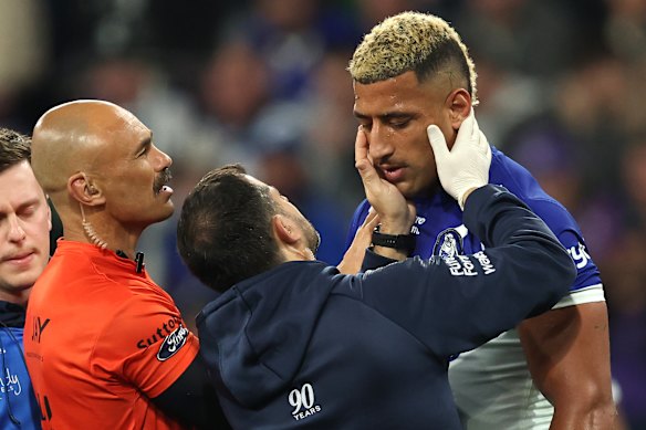 Viliame Kikau is treated during Friday night’s clash with Melbourne.