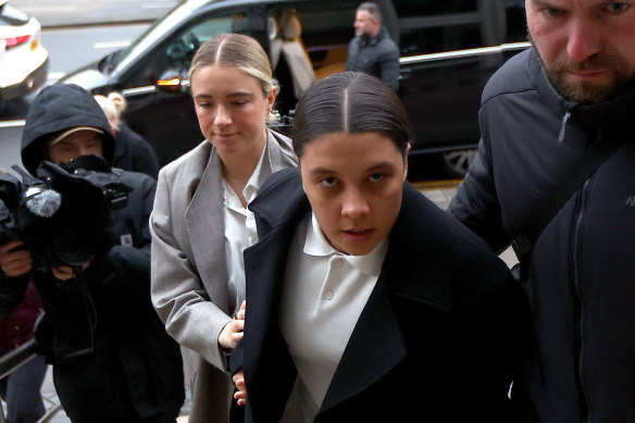 Matildas captain and Chelsea striker Sam Kerr arrives at Kingston Crown Court on Monday with fiancee Kristie Mewis.