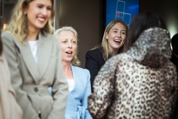 Amelia Hamer (right) and Jacqueline Blackwell (light blue jacket) greet Liberal Party members at Caulfield Racetrack on Sunday for the preselection meeting.