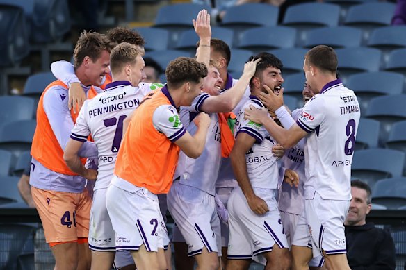 Perth Glory’s Charbel Shamoon celebrates kicking a goal with teammates. 