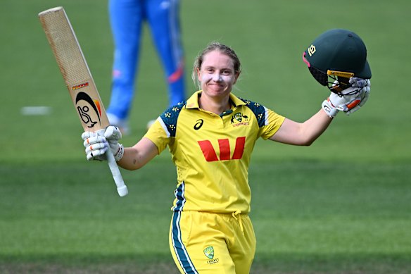 Alyssa Healy of Australia celebrates getting to her century.