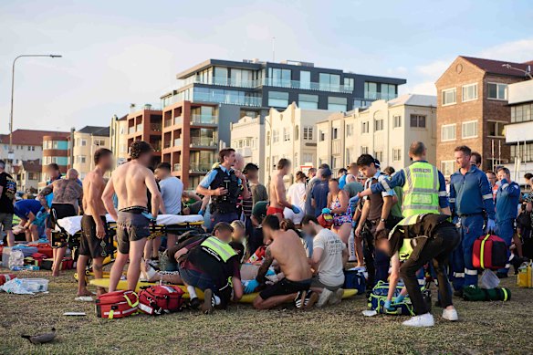 Members of the public help emergency services following a mass shooting at Bondi Beach.