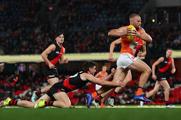 Jake Stringer of the Giants runs with the ball during the round 19 AFL match between Essendon Bombers and GWS Giants.