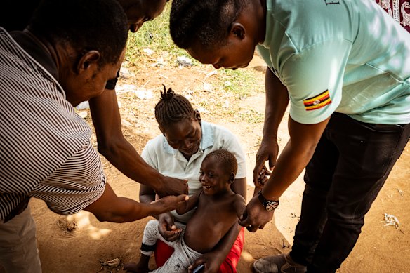  Fred Alimet plays with a happy 3-year-old Felix after releasing him from his tether.