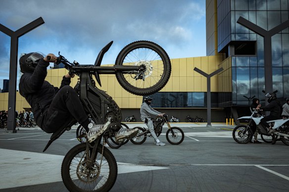 A ride-out participant does a wheelie at a car park in South Wharf. The mass of cyclists and illegal e-bikes are seen riding through Melbourne CBD, often causing traffic mayhem. 